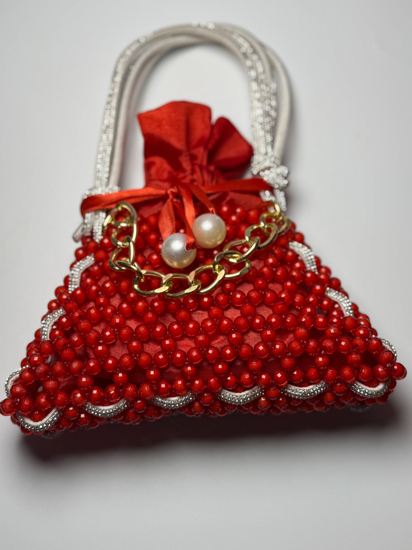 Crimson Charm red handbag with pearl embellishments and gold chain accent